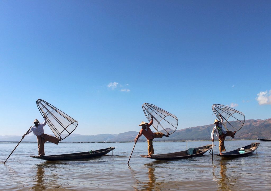 Leg rowing fishermen displaying their great balance in Inle Lake Myanmar Burma